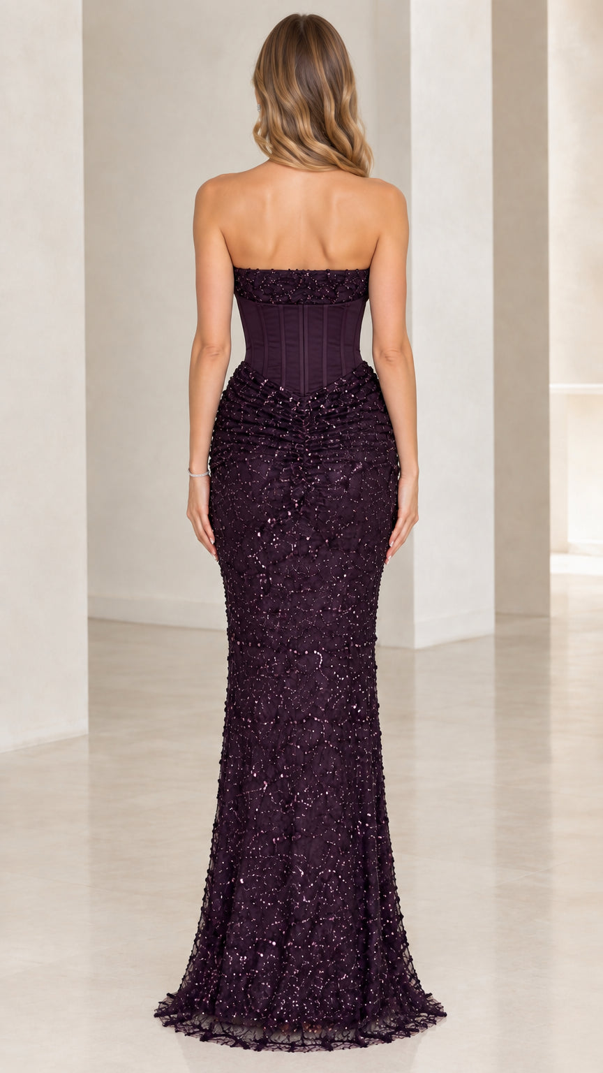 Back view of woman wearing plum strapless formal gown
