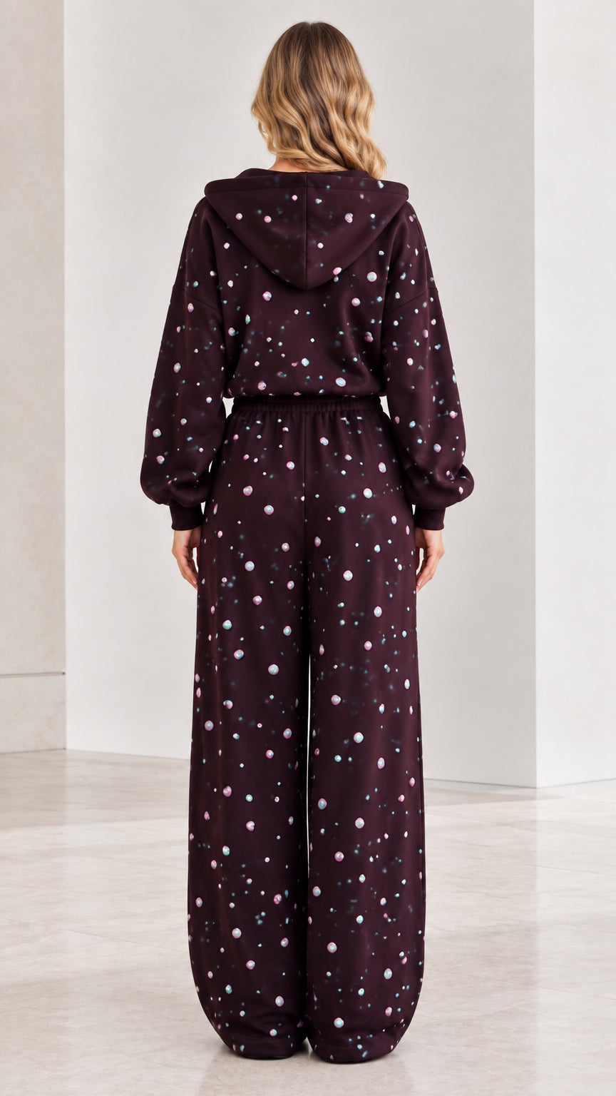 Back view of burgundy hooded wide leg jumpsuit with rhinestone details