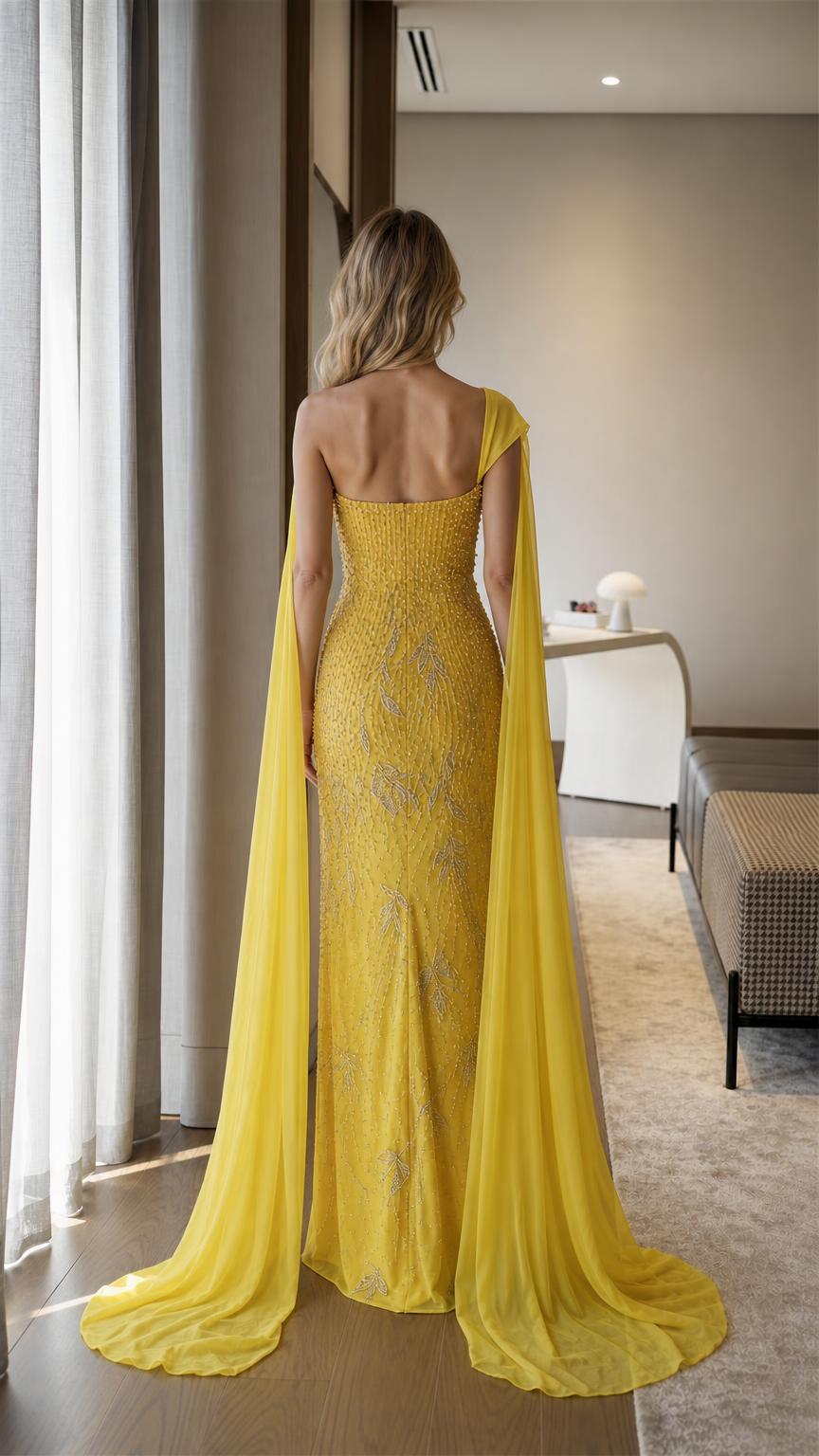 Back view of yellow beaded gown with long cape