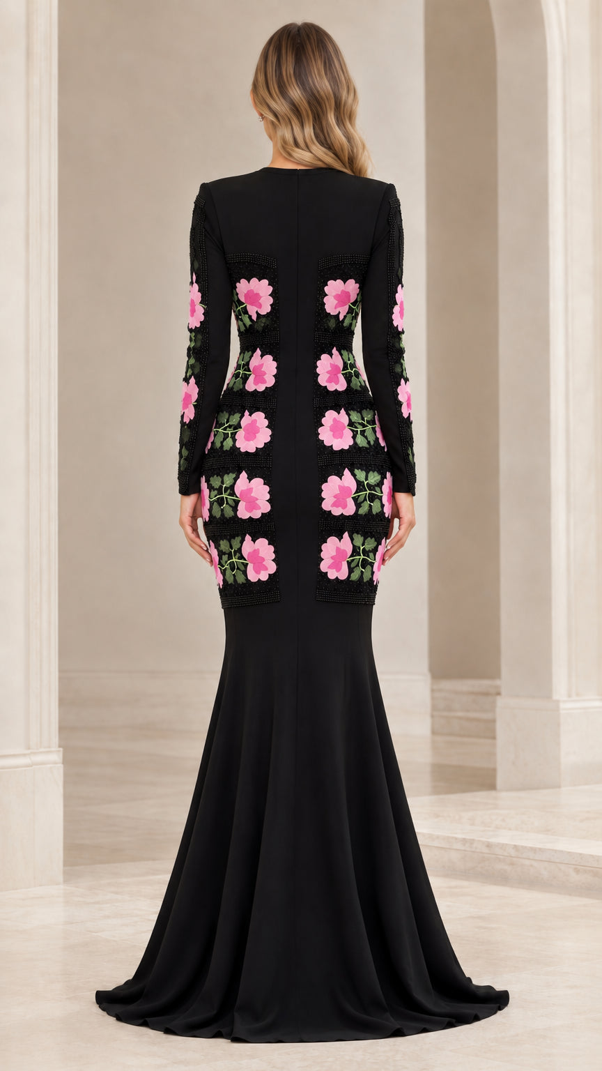 Back view of black long sleeve formal gown featuring floral placement details