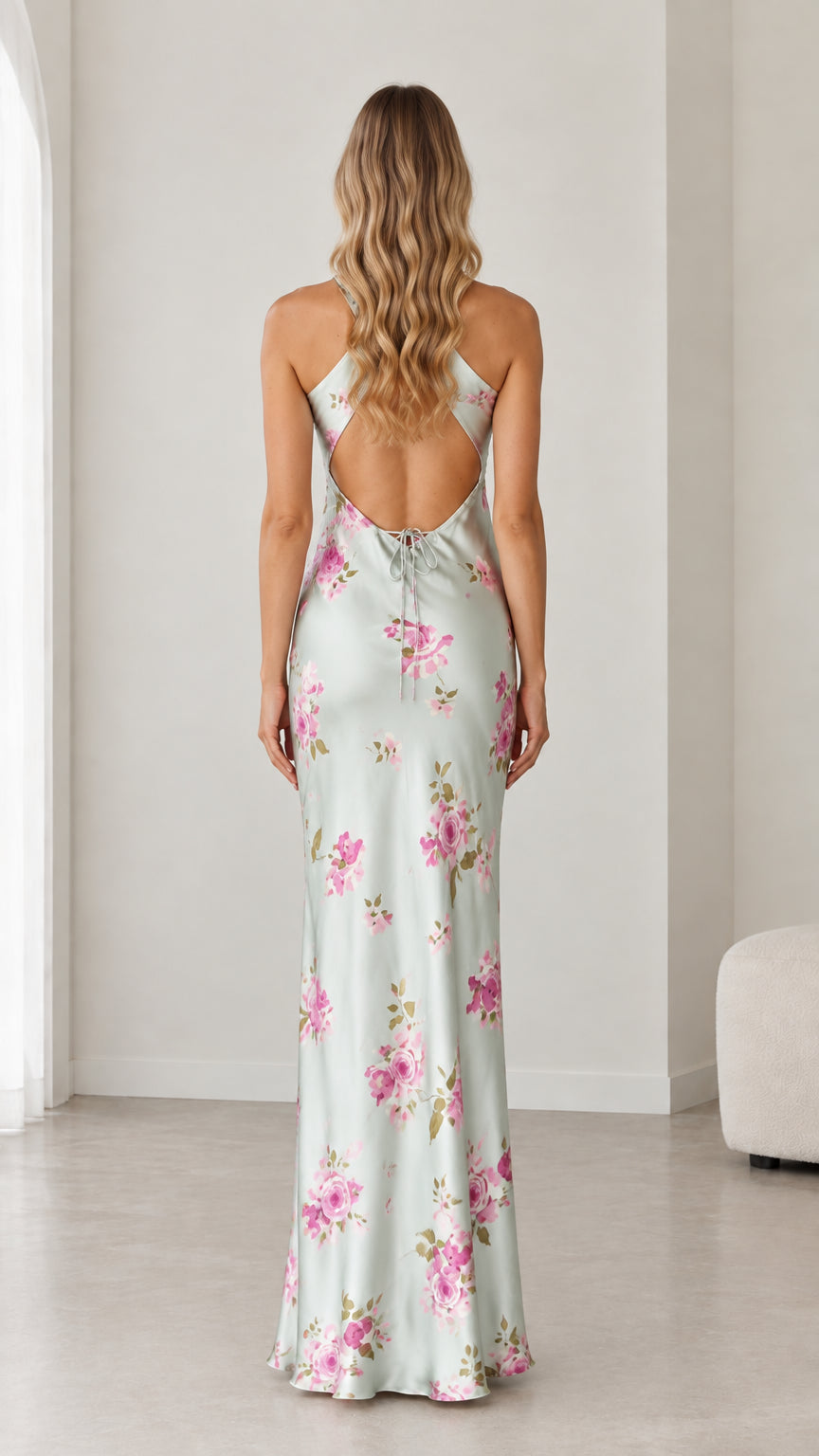 Model wearing sage green floral satin maxi dress showing open cutout back