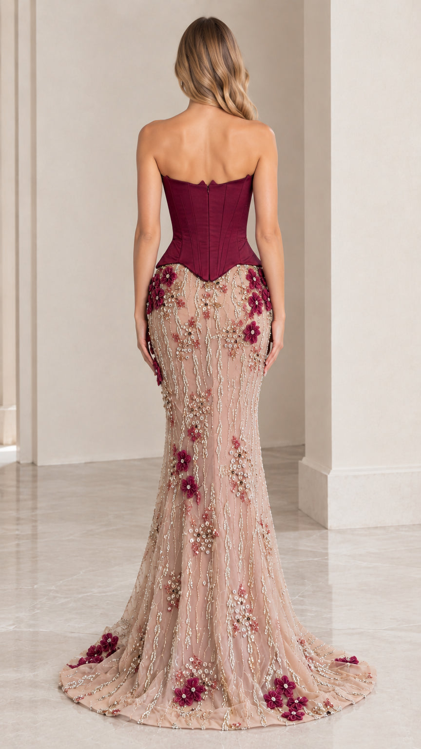 Back view of woman wearing burgundy corset formal gown showing structured boning and mermaid train