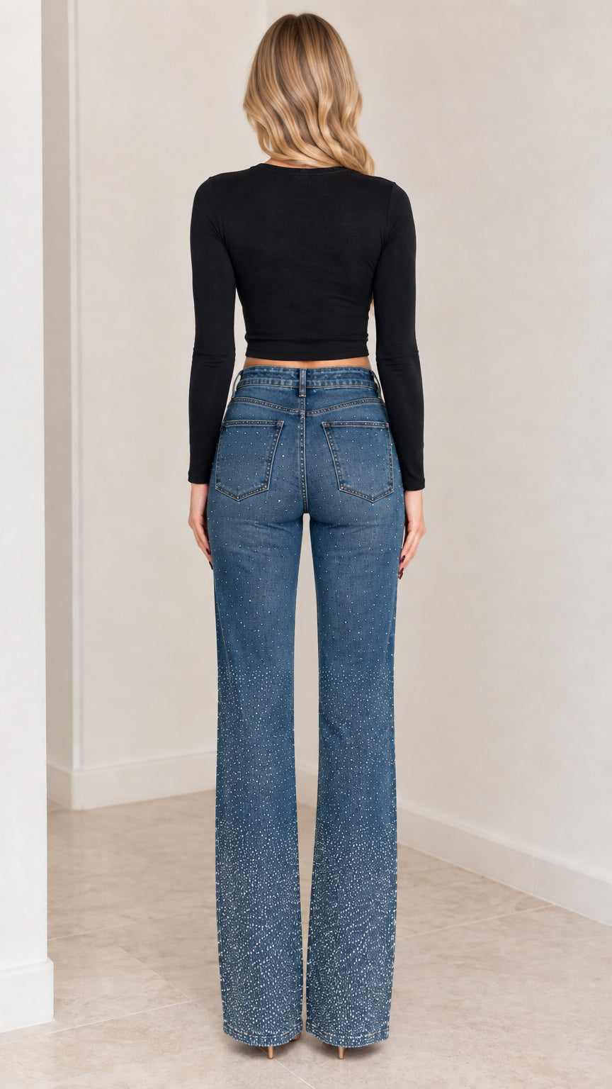 Back view of model in rhinestone-embellished high-rise flare jeans