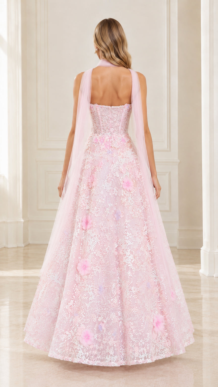 Back view of model in blush pink strapless sequin gown highlighting the straight-back cut and drape