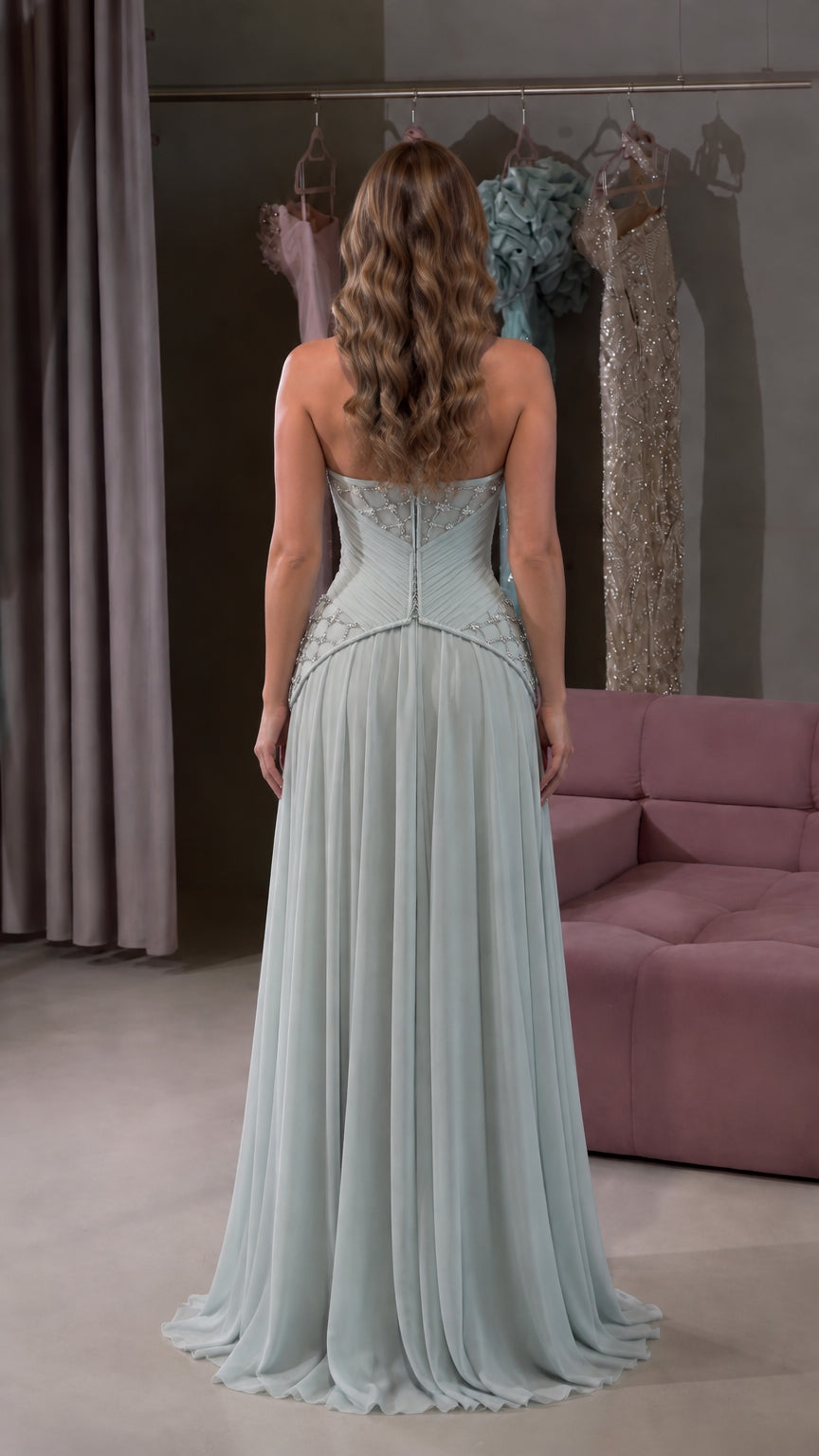 Back view of model displaying open back with lace-up corset detail in Sage Green