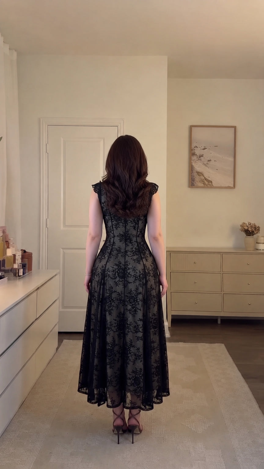 Back view of model wearing black floral lace corset midi dress with zipper detail