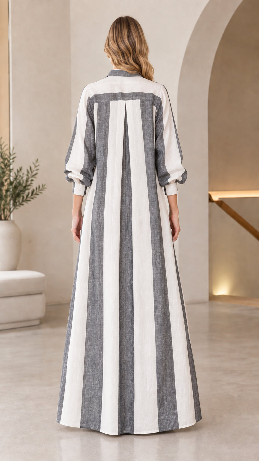 Back view of charcoal grey vertical striped maxi duster coat showing inverted box pleat