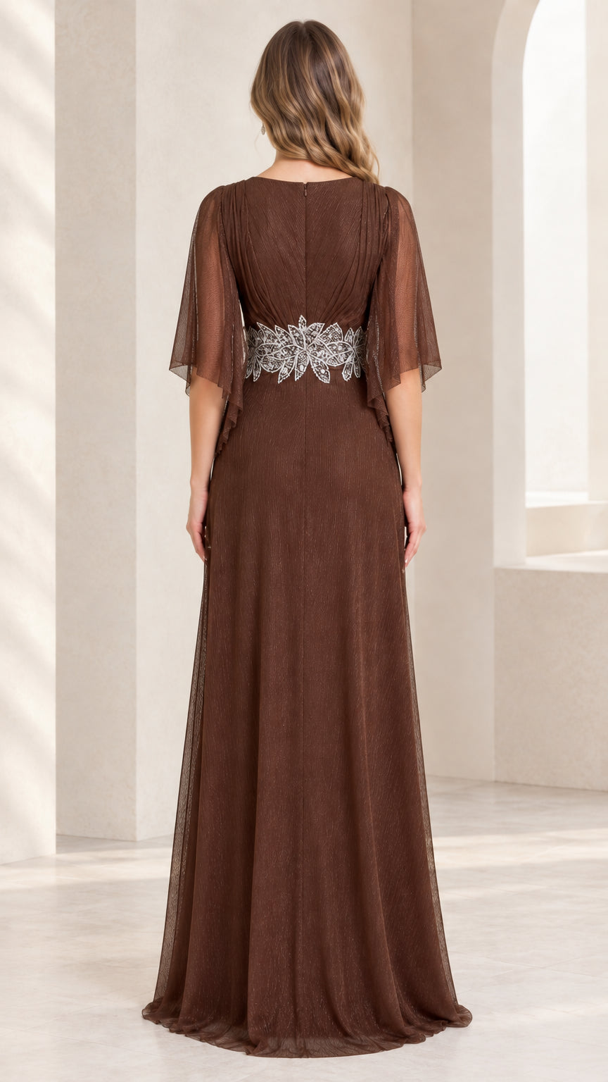 Back view of model wearing floor-length brown evening gown with flutter sleeves