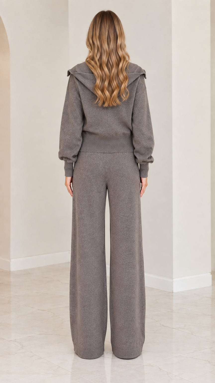 Back view of woman wearing charcoal grey knit jacket with sailor collar and wide-leg pants