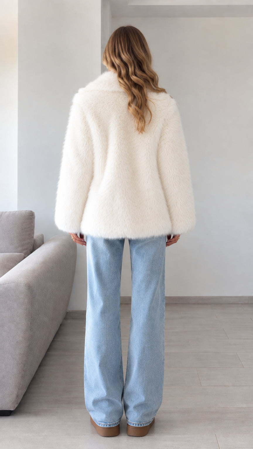 Back view of model wearing ivory shaggy faux fur coat
