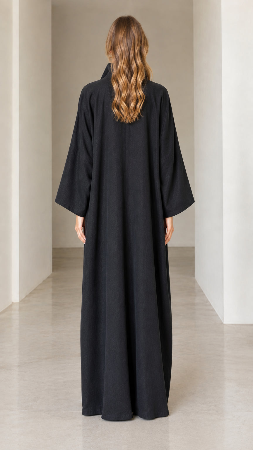 Back view of model in full-length black collared maxi dress