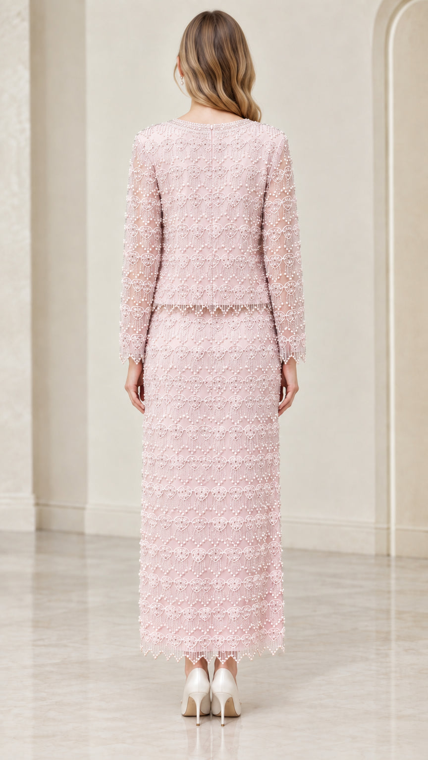 Back view of woman wearing blush pink beaded two-piece formal evening set