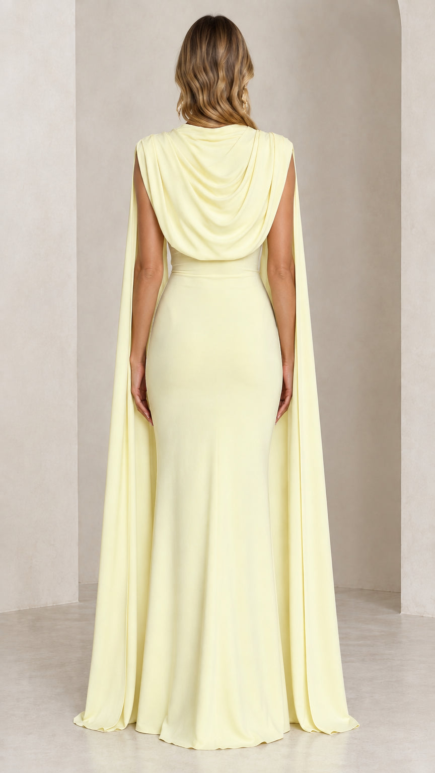 Back view of butter yellow maxi dress highlighting the cowl back and cape panels