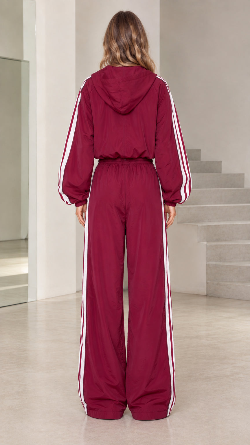 Back view of burgundy hooded tracksuit set showing attached hood and wide pants