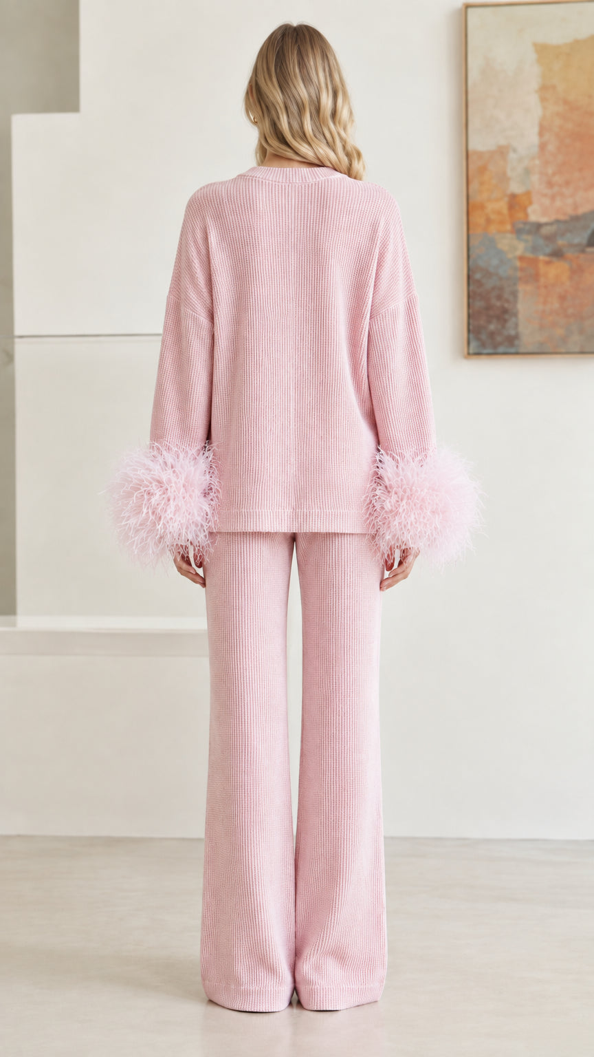 Back view of woman wearing pastel pink ribbed knit matching lounge set