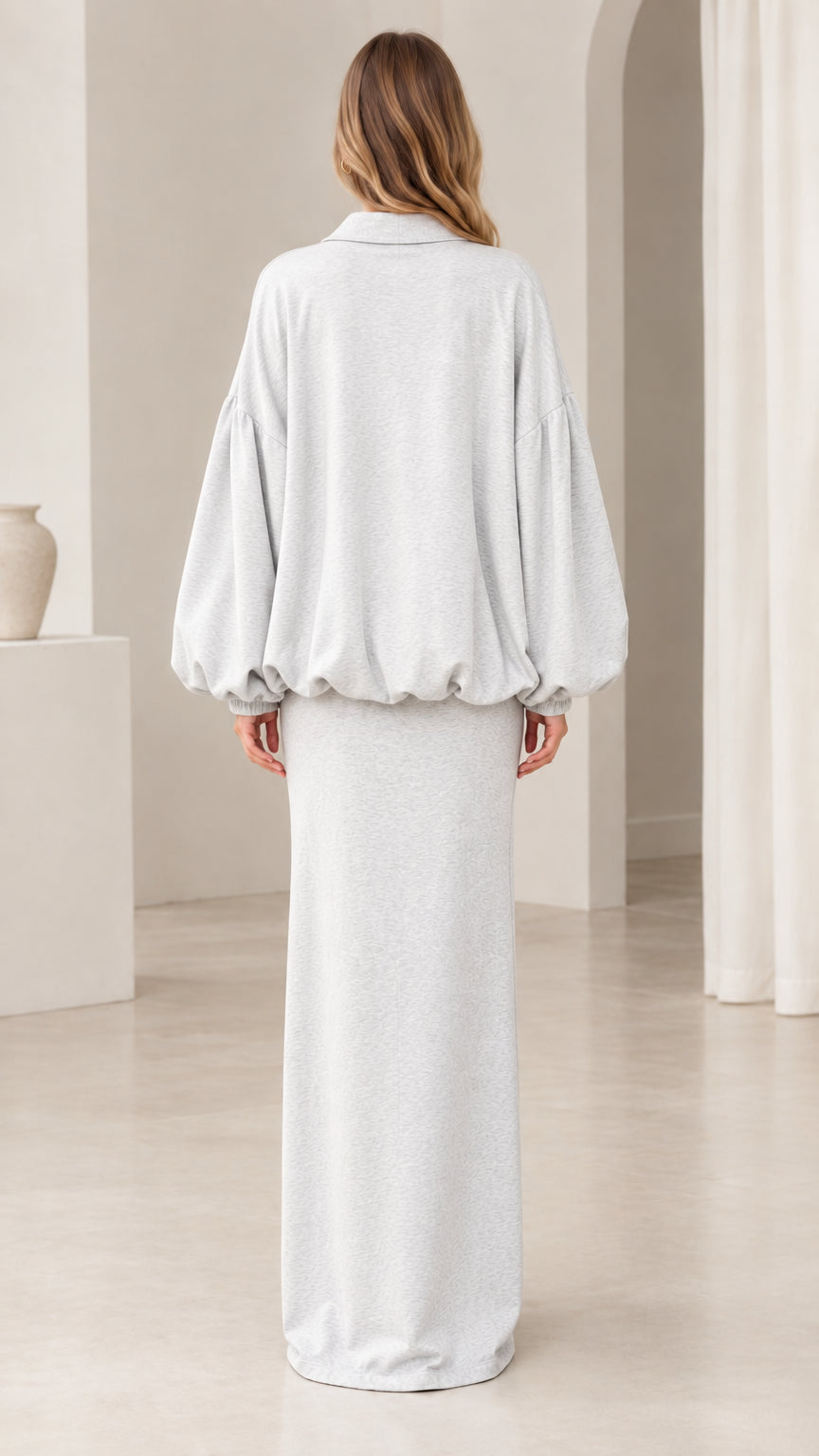 Back view of model wearing heather grey bubble jacket and maxi skirt set