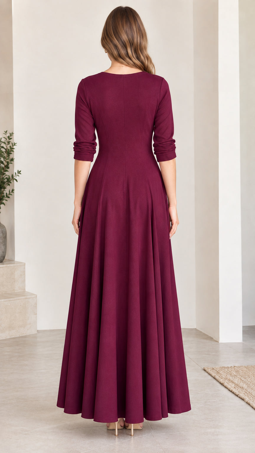Back view of woman wearing burgundy round neck long sleeve maxi dress