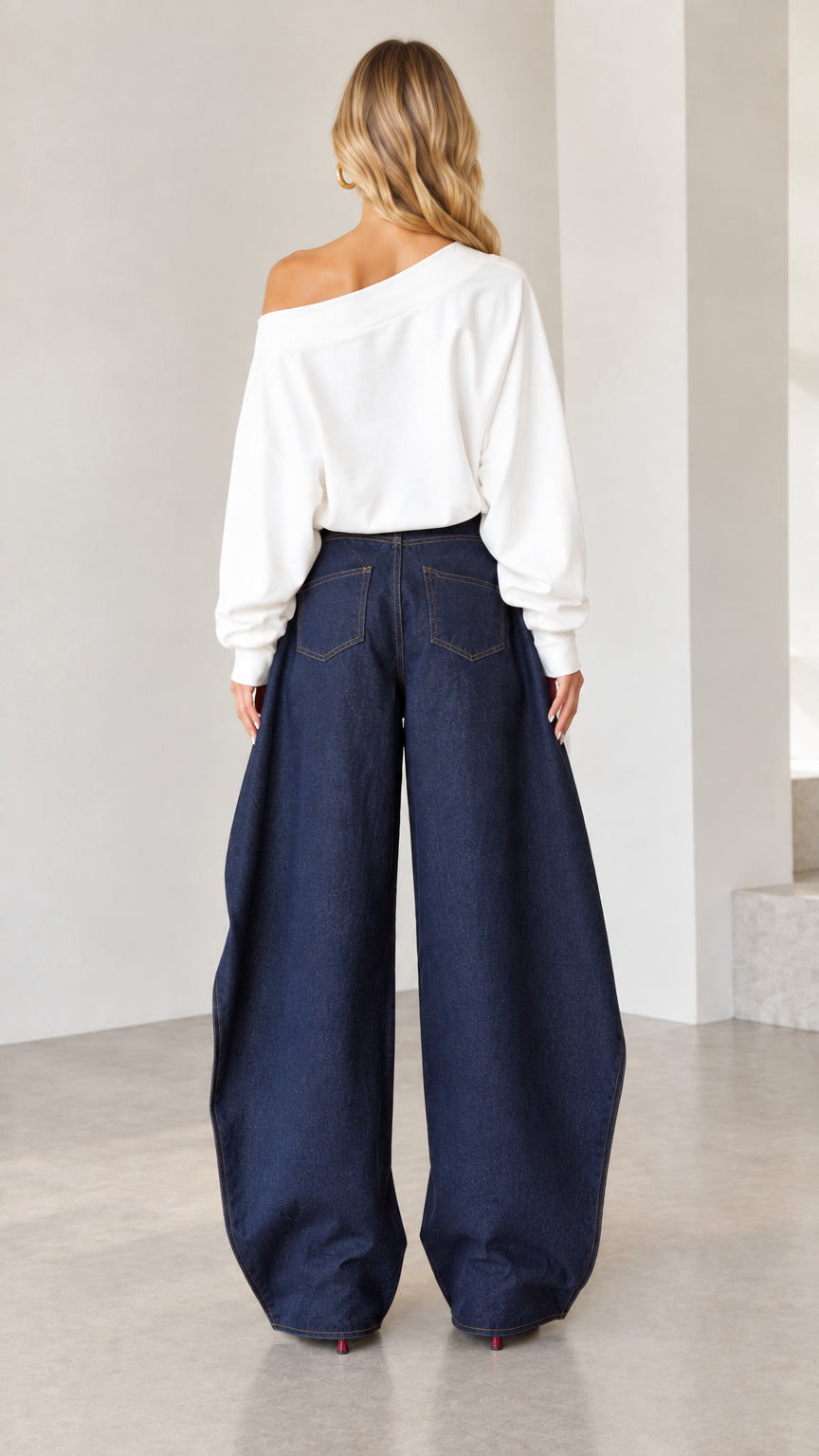 Back view of women wearing high-rise dark blue wide-leg denim pants with classic rear pockets