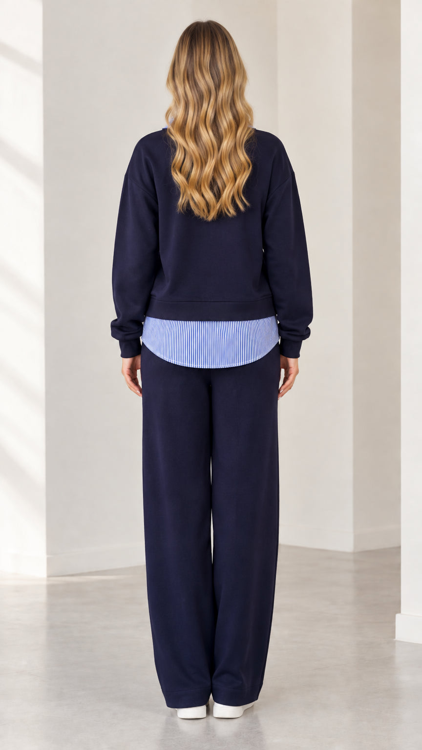 Back view of navy blue loungewear set with layered striped hem detail