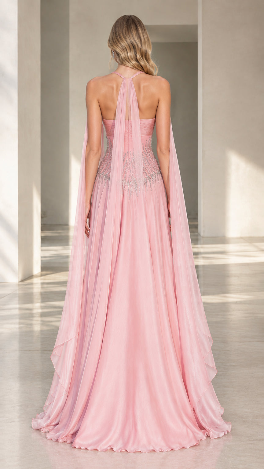 Back view of pink halter evening dress highlighting back cape details and flowing train