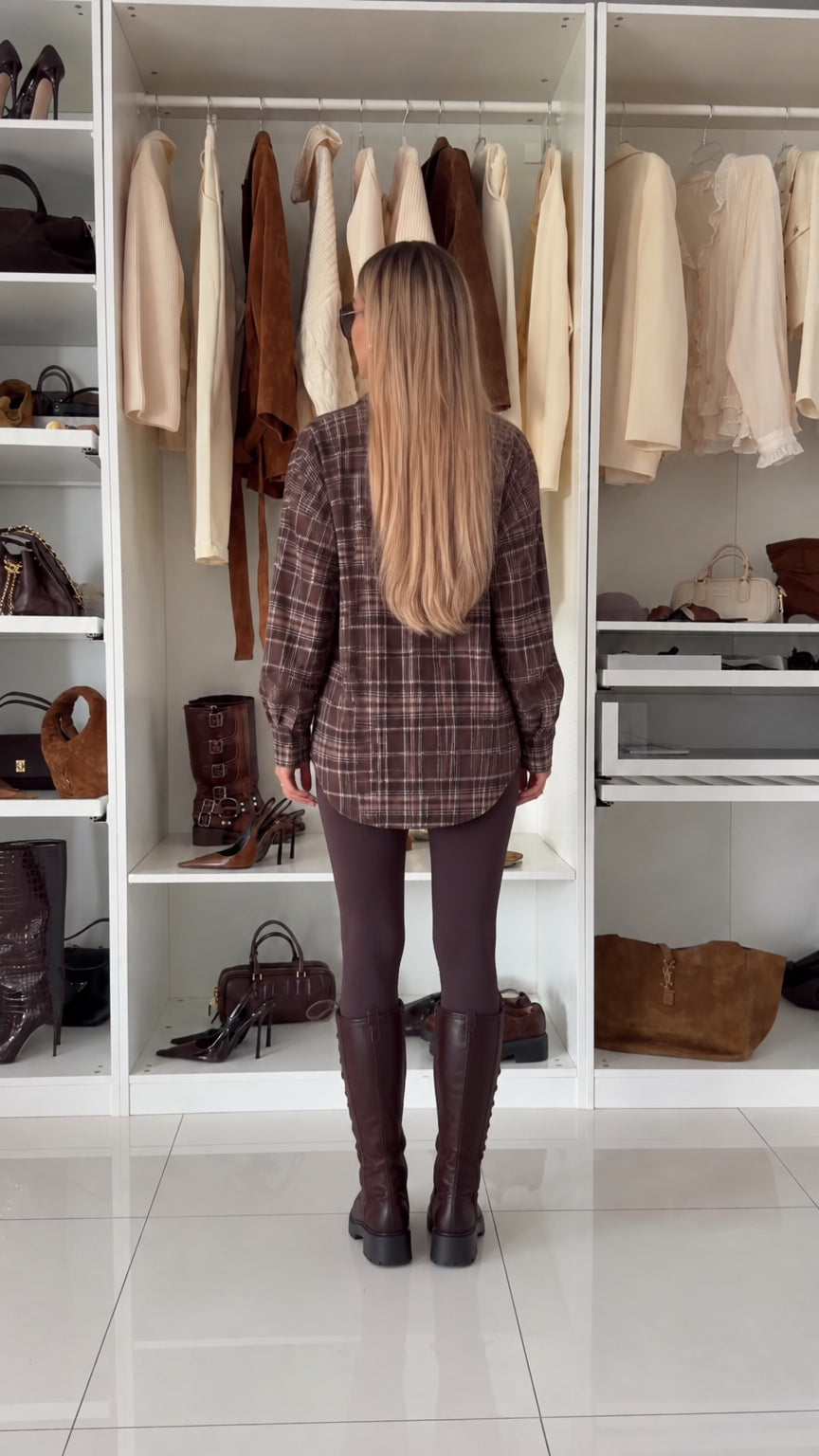 Back view of oversized brown plaid flannel shirt showing curved hemline
