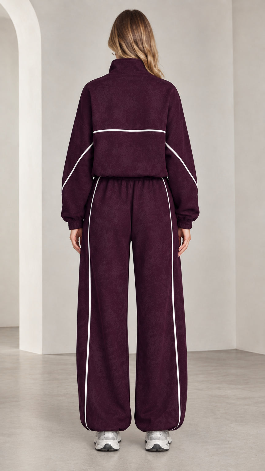 Back view of woman wearing burgundy quarter-zip sweatshirt and matching sweatpants