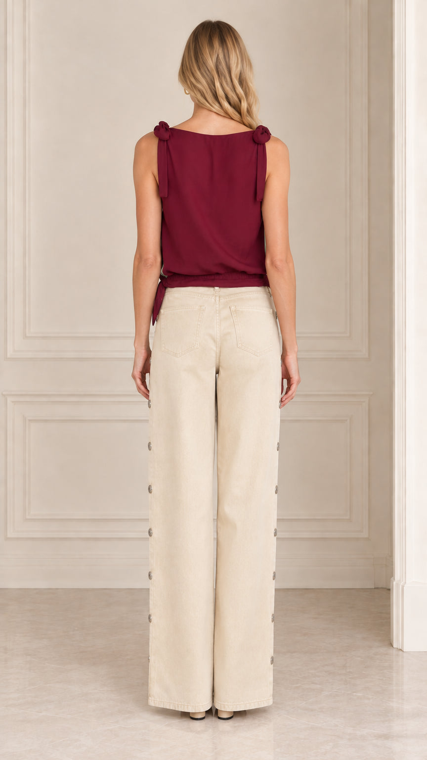 Back view of women's burgundy sleeveless top with shoulder ties and solid back