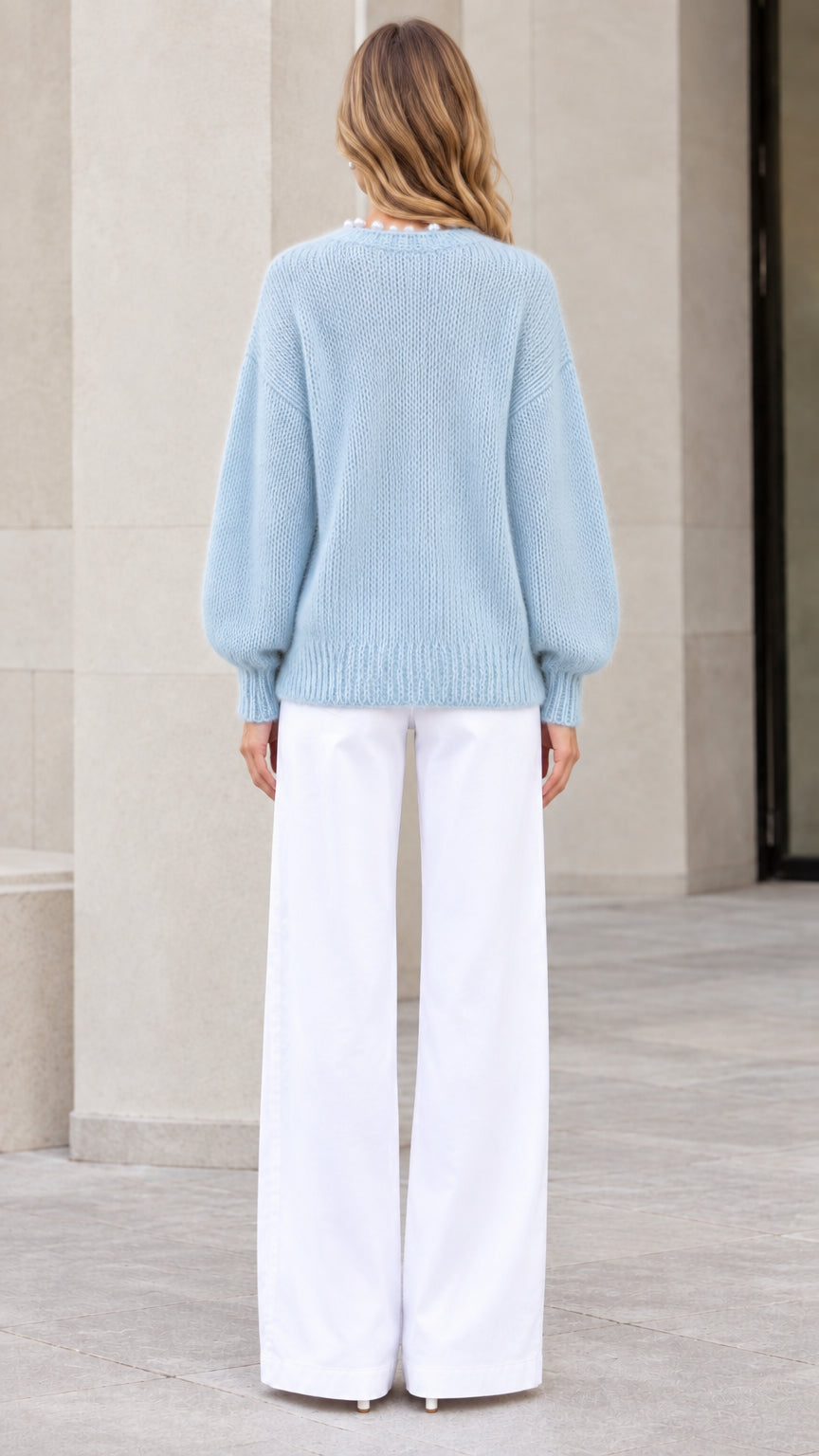 Model wearing Light Blue pearl-trimmed knit cardigan sweater back view