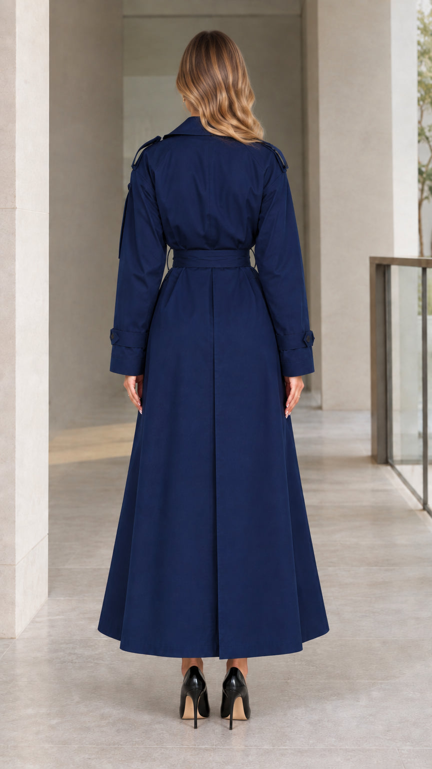 Back view of model wearing Navy Blue maxi trench coat with back storm flap