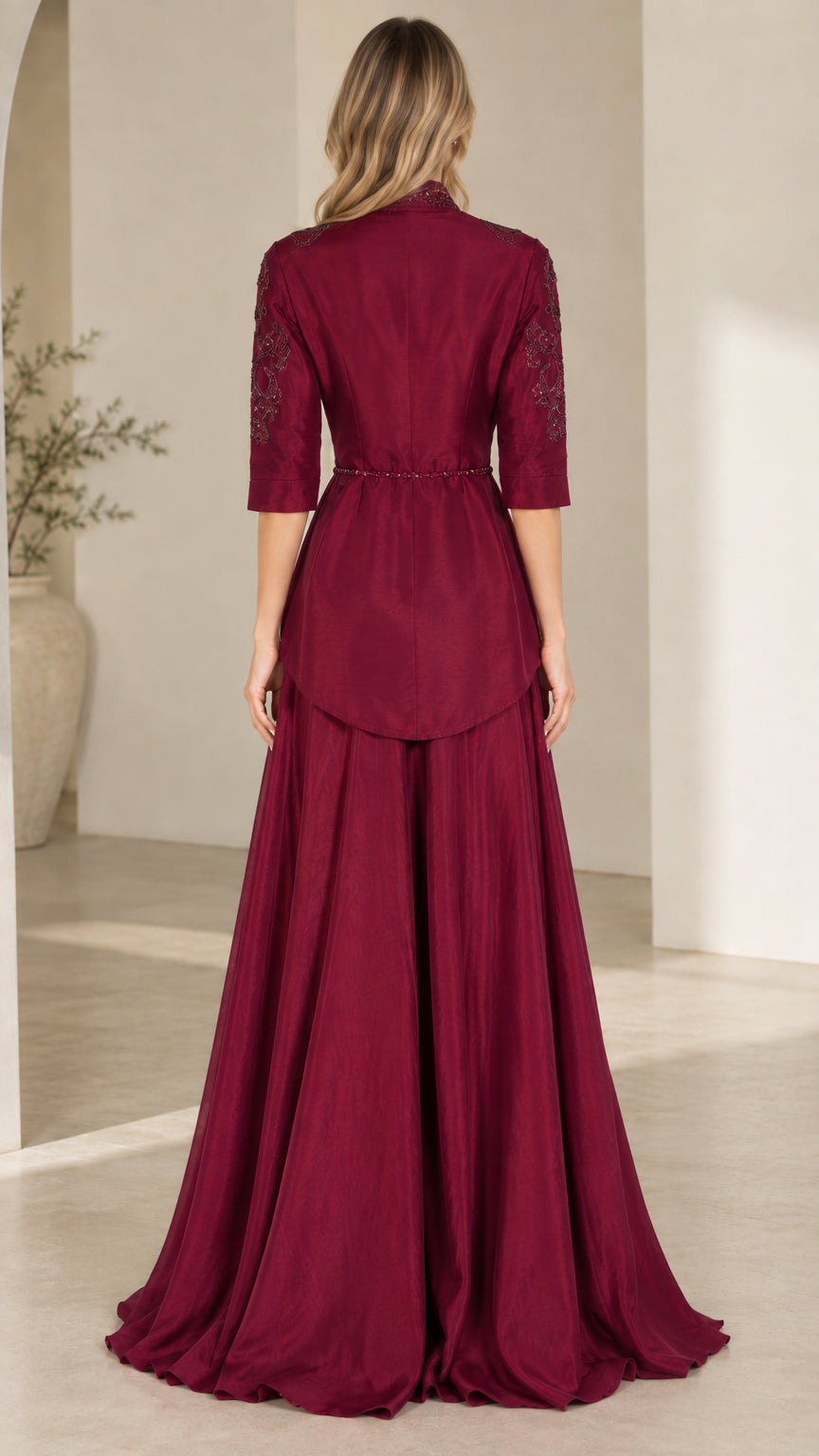 Back view of burgundy formal maxi dress with tailored waist and flowing skirt