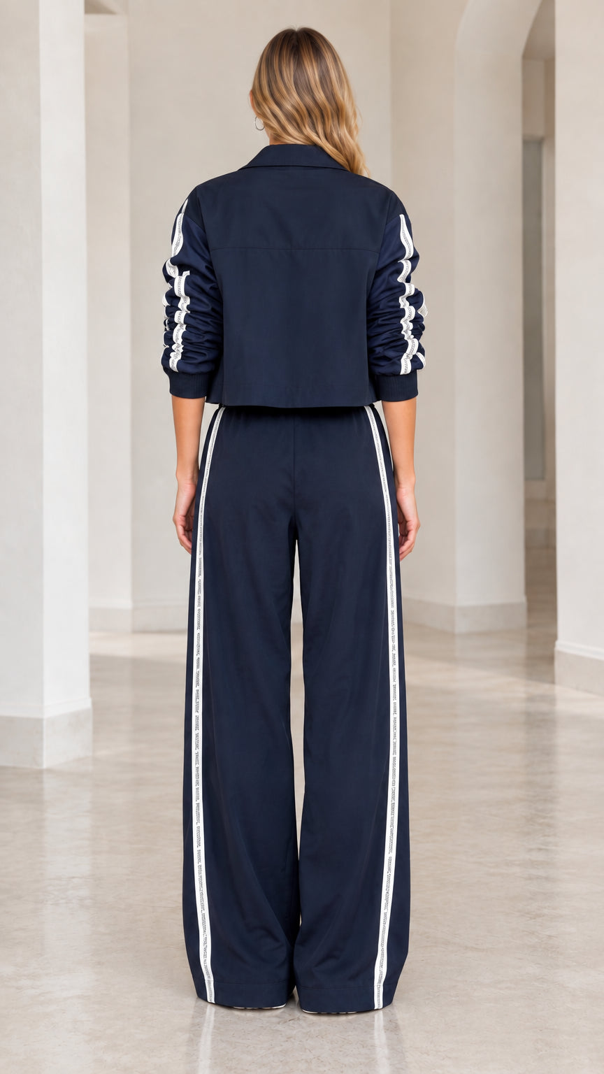 Back view of model in Navy Blue track pants and cropped jacket set