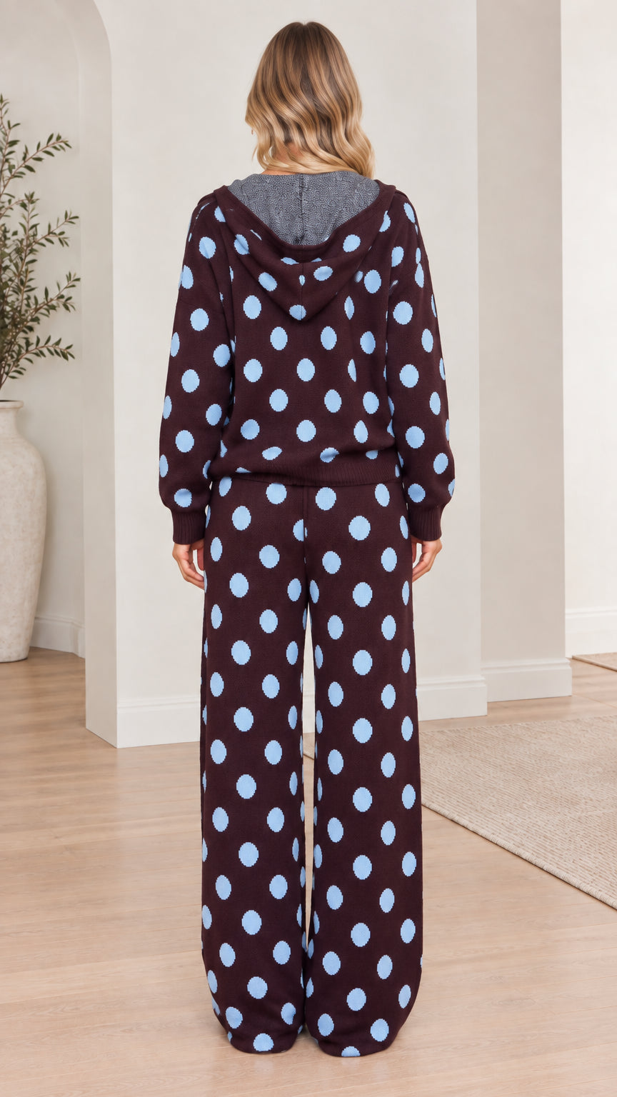 Back view of model showing hood and wide-leg pants in brown polka dot knit set