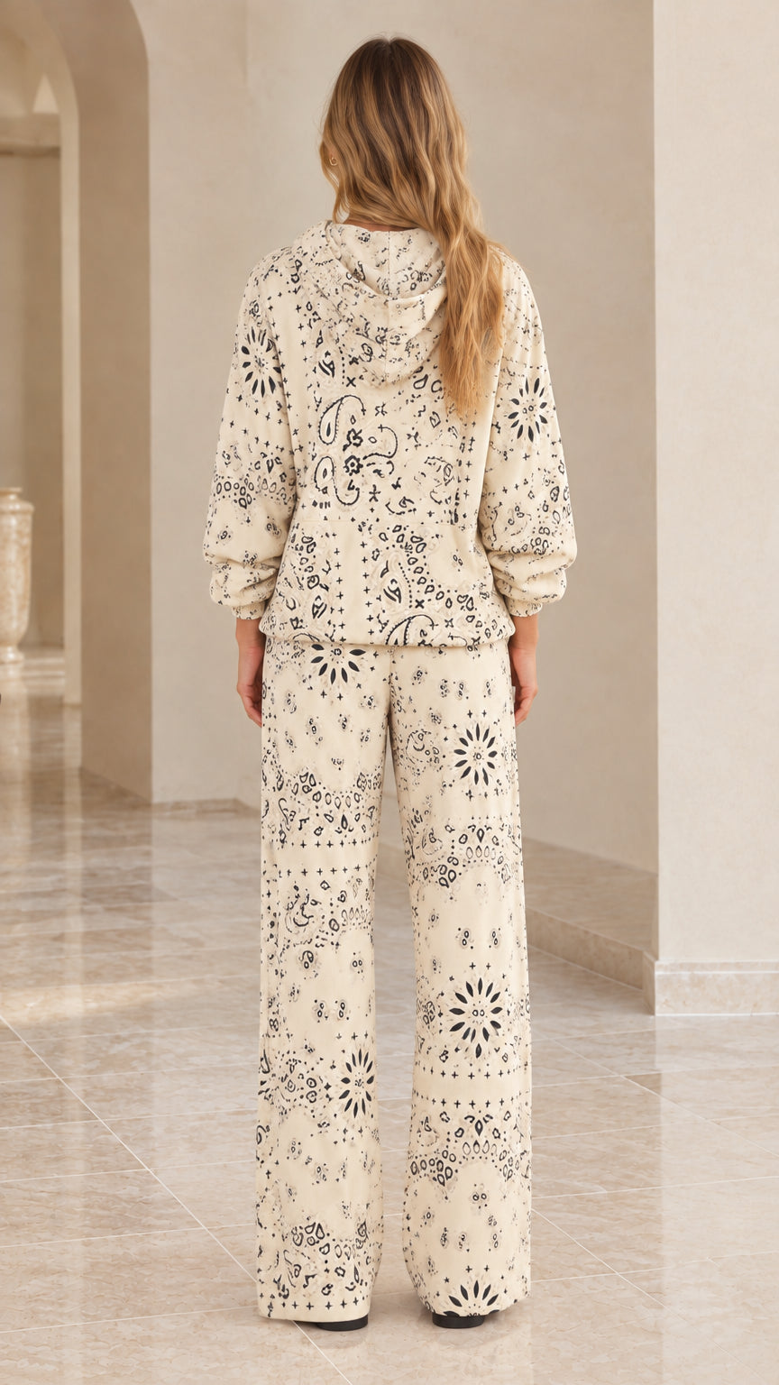 Back view of woman wearing cream bandana print hoodie and matching wide-leg pants