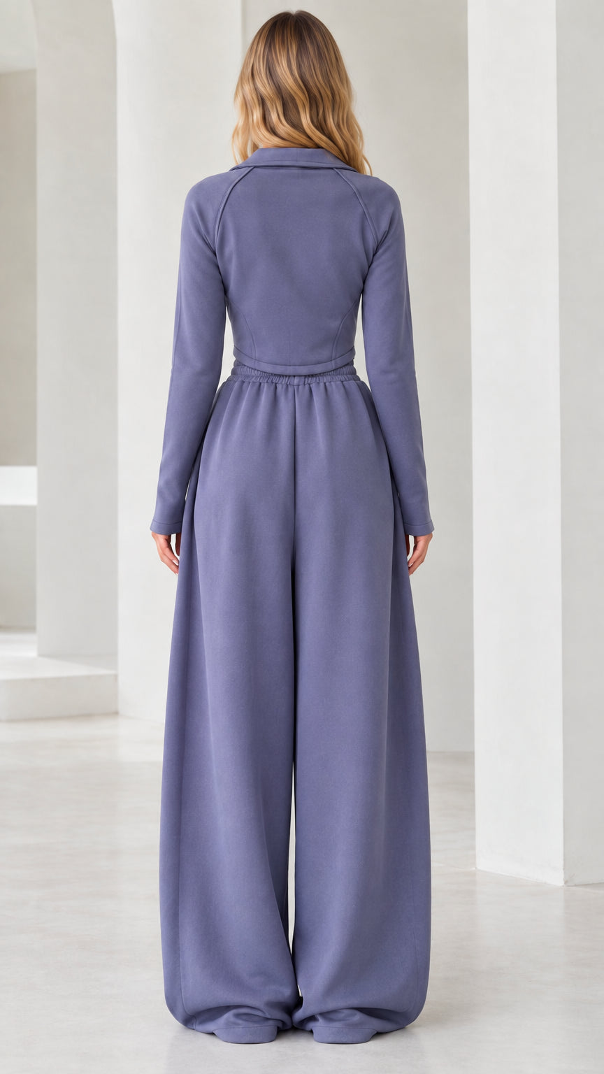 Back view of model wearing dusty blue two-piece quarter-zip top and wide-leg trousers