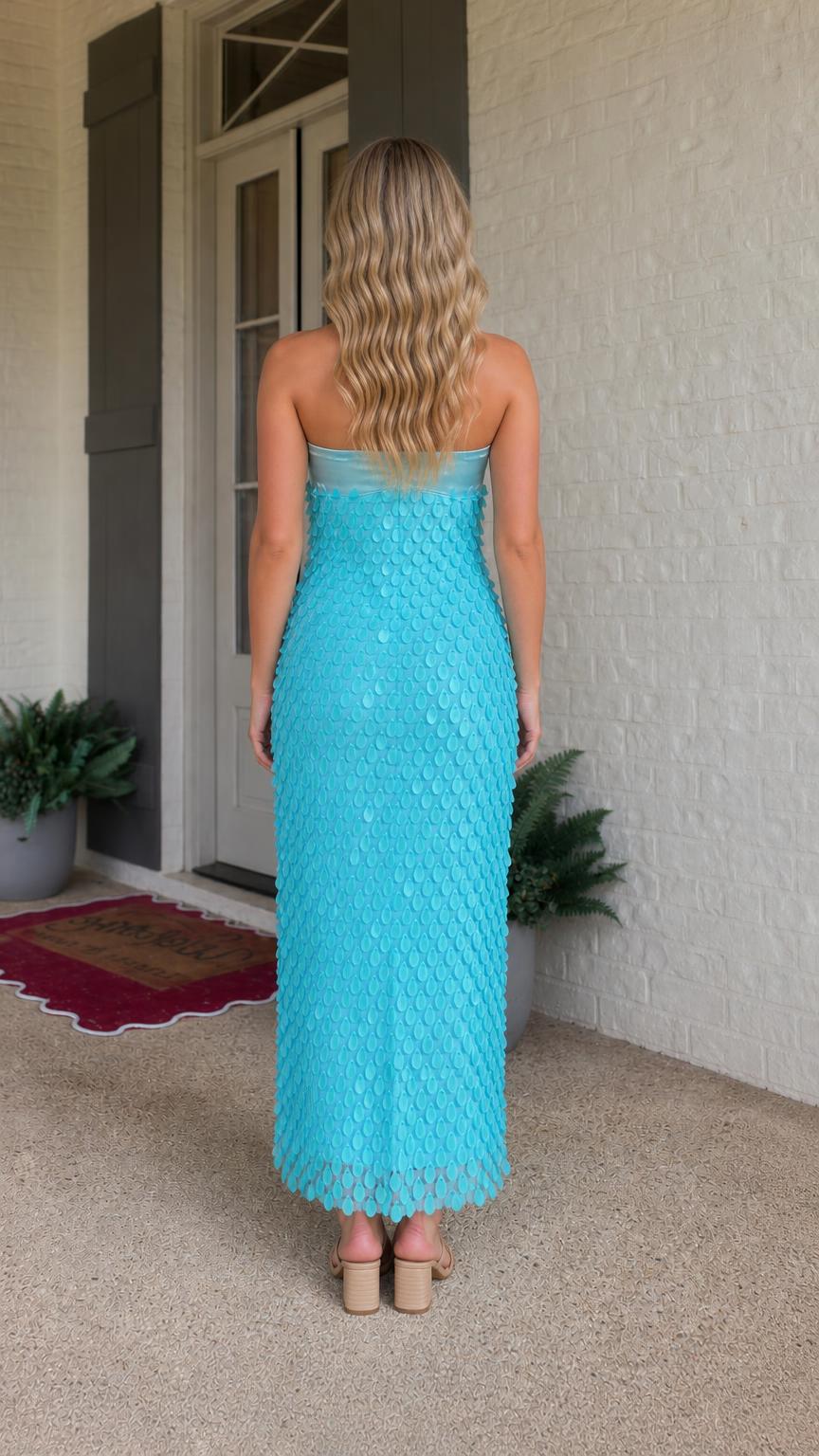 Back view of model in turquoise strapless maxi dress