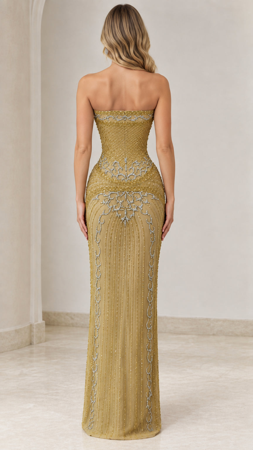 Back view of the gold strapless beaded maxi gown showcasing column silhouette