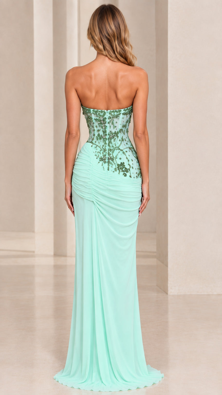 Back view of model in mint green strapless back embellished evening gown