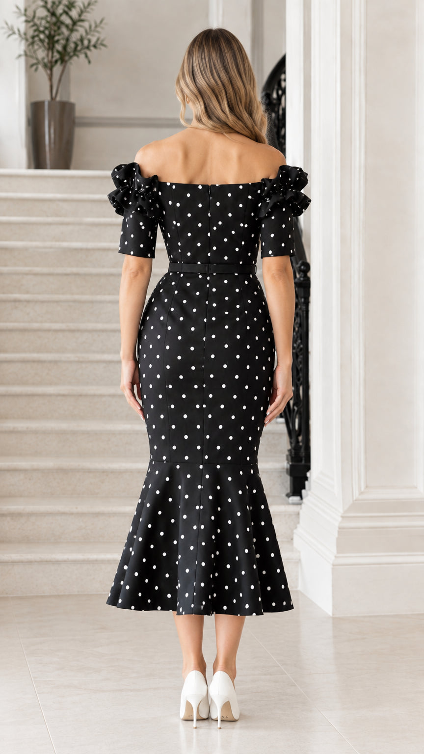 Back view of black polka dot midi dress with off-the-shoulder backline