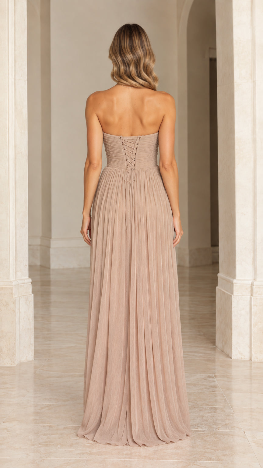 Back view of model showing the lace-up corset back on a taupe maxi dress