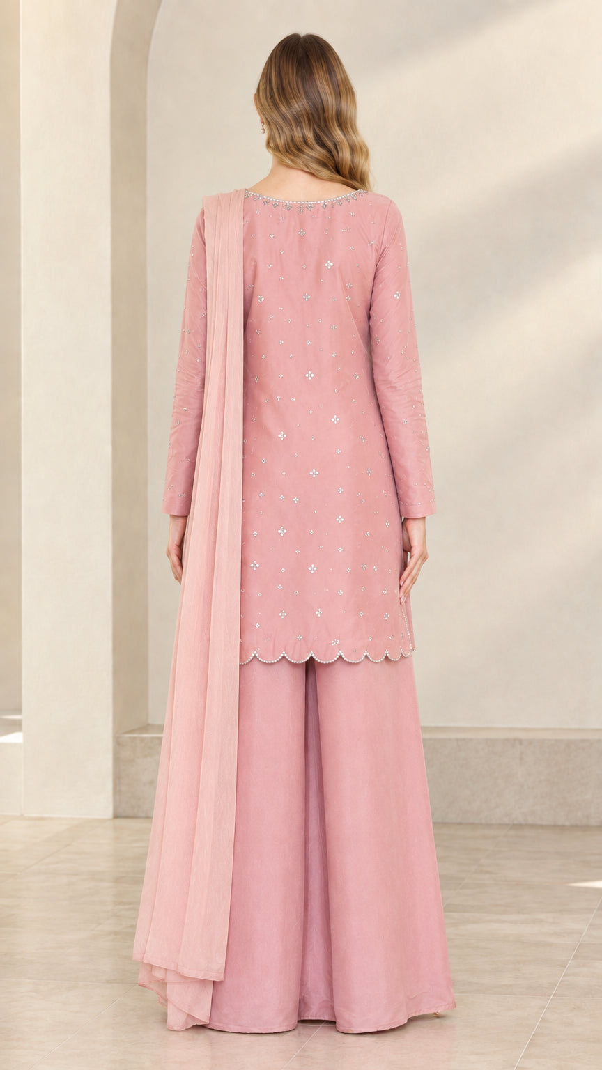 Back view of dusty rose 3-piece formal outfit showing drape and scalloped hem