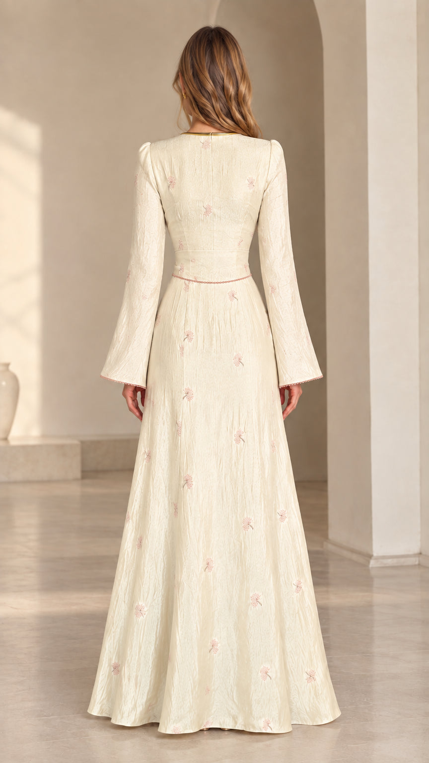 Back view of model wearing cream floral jacquard bell sleeve maxi dress