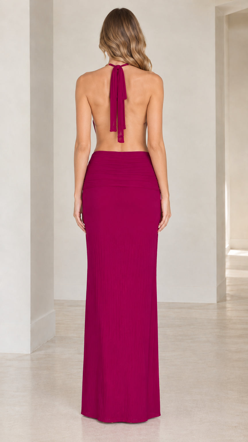 Back view showing halter tie and open back design on the magenta evening dress