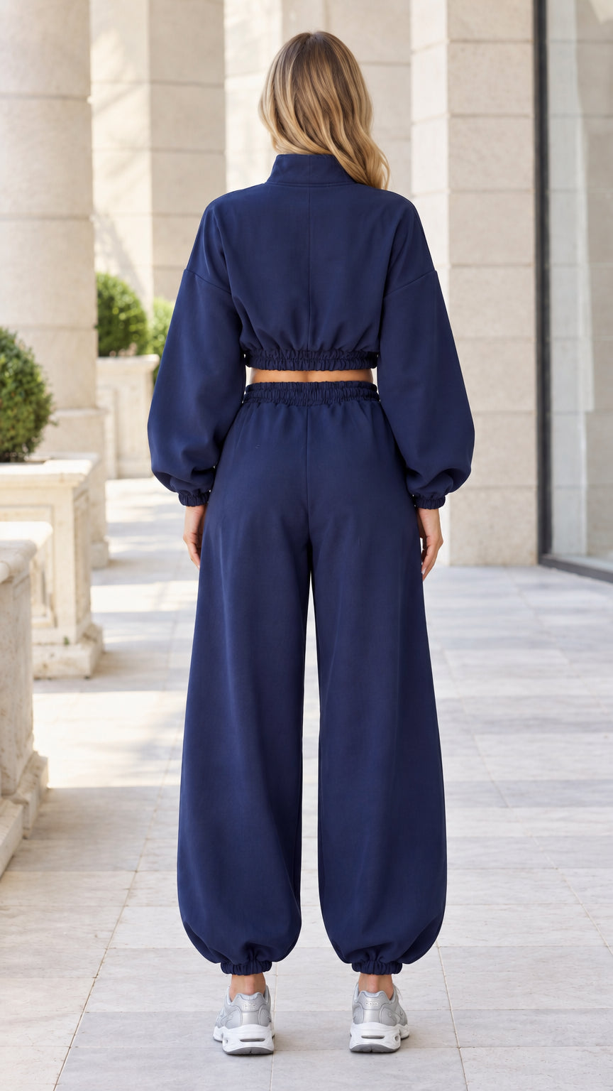 Back view of model wearing Navy Blue tracksuit set with cinched waist and cuffs