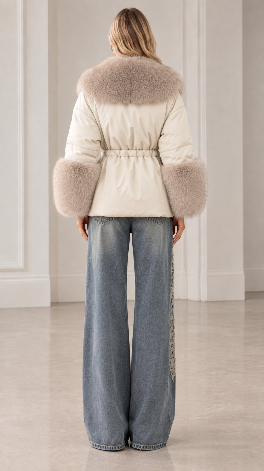 Back view of cream quilted puffer jacket showing cinched waist and fur collar