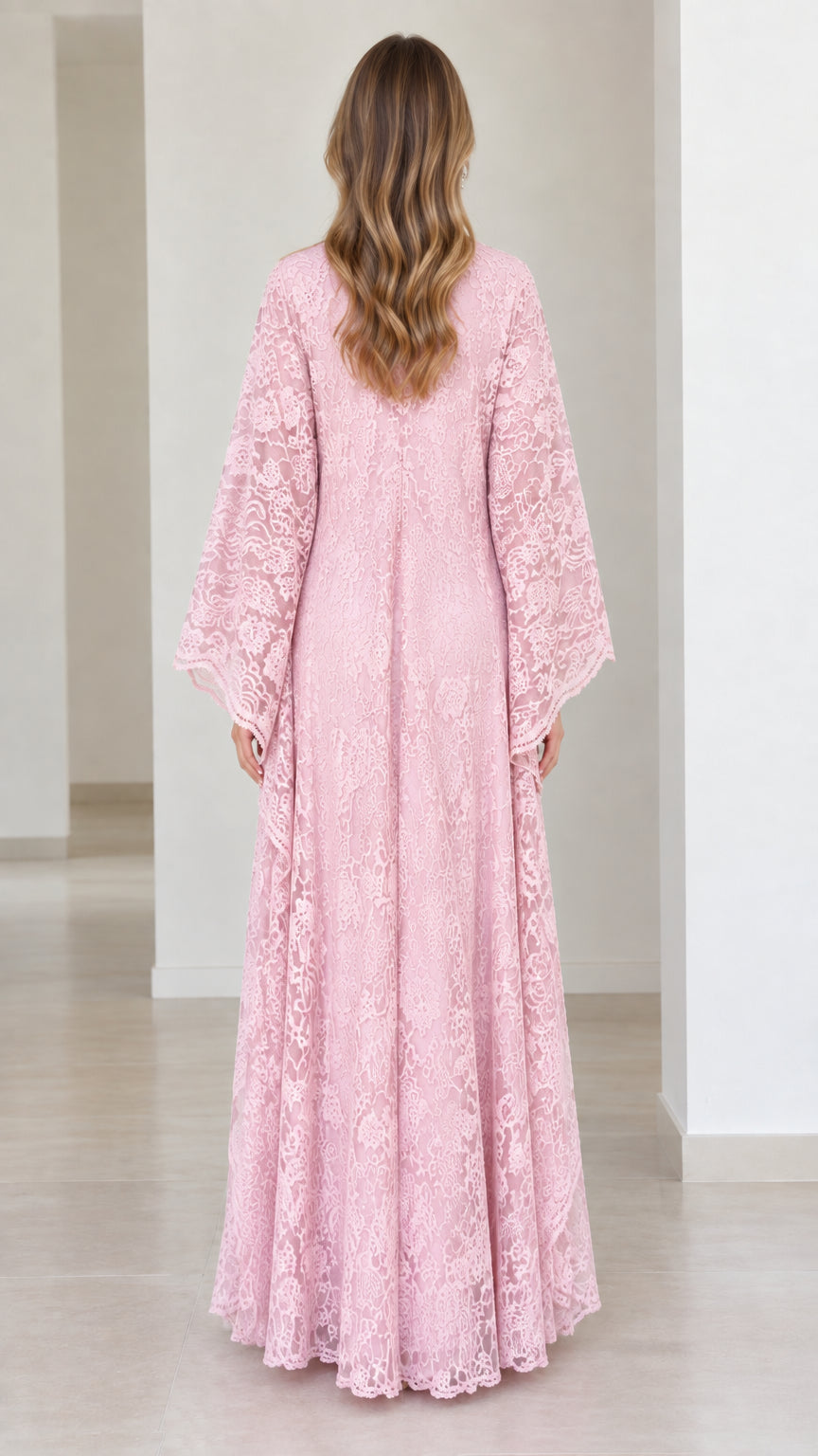 Back view of model wearing pink lace maxi gown showing floor-length flowing cut