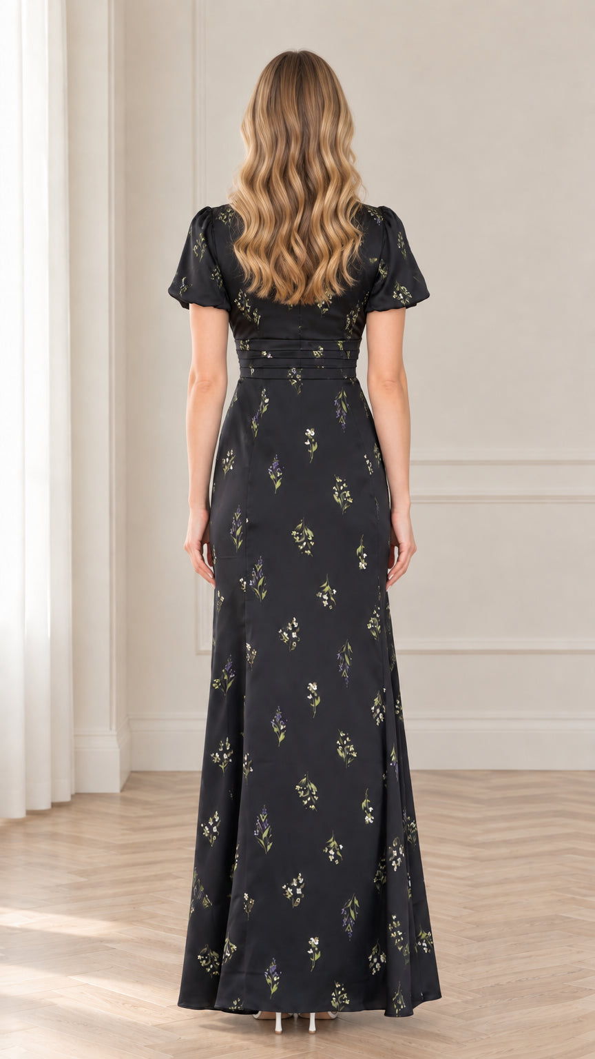Back view of model in black floral maxi dress showing seamless zip and tailored fit