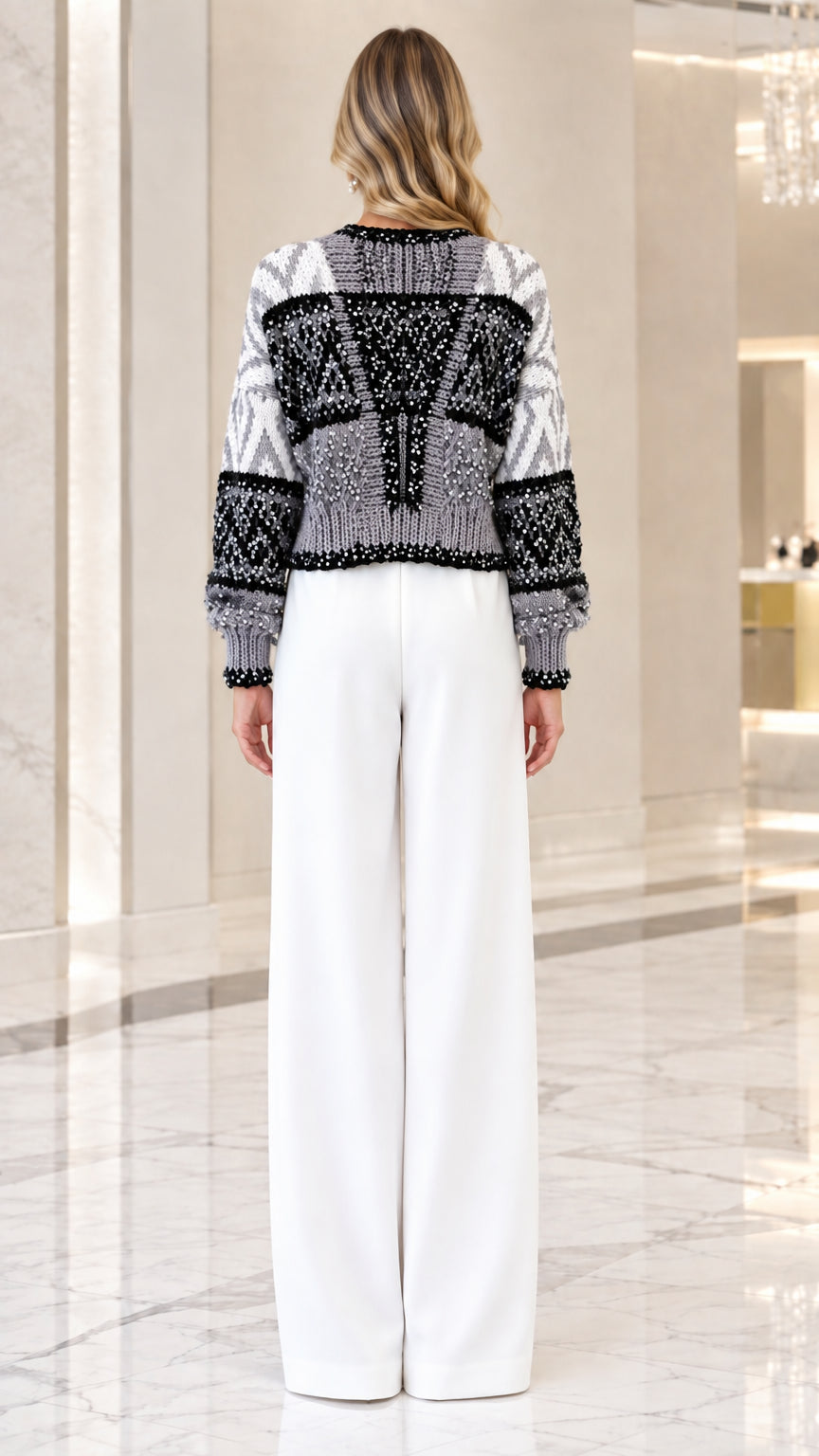 Back view of model showing geometric pattern on gray sequin knit sweater