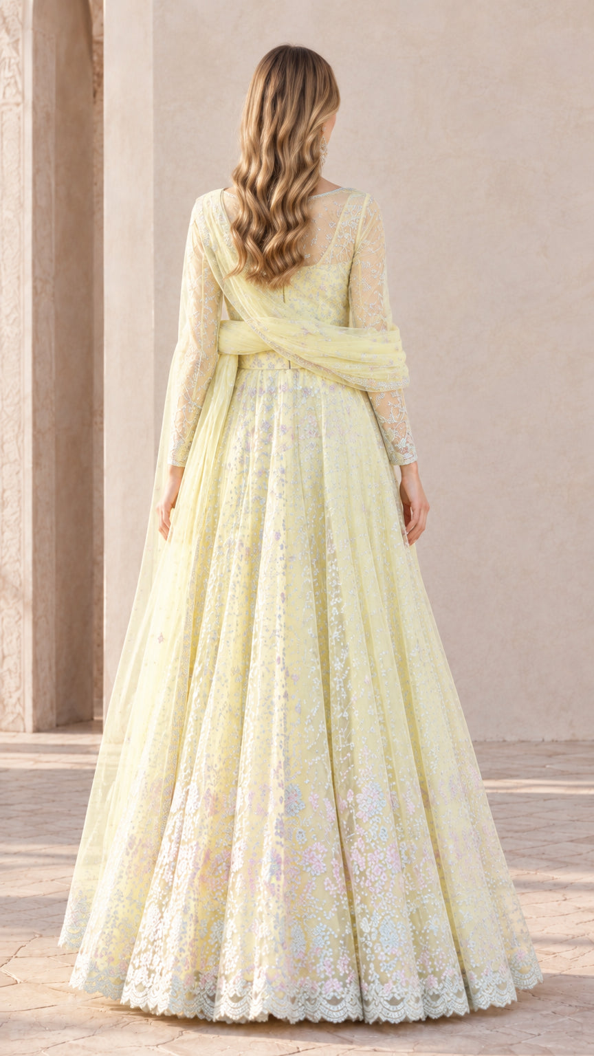 Back view of woman wearing Pastel Yellow embroidered Anarkali gown with draped scarf
