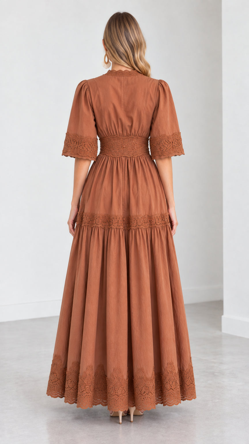 Back view of woman wearing a rust brown tiered maxi dress showing waist lace panel