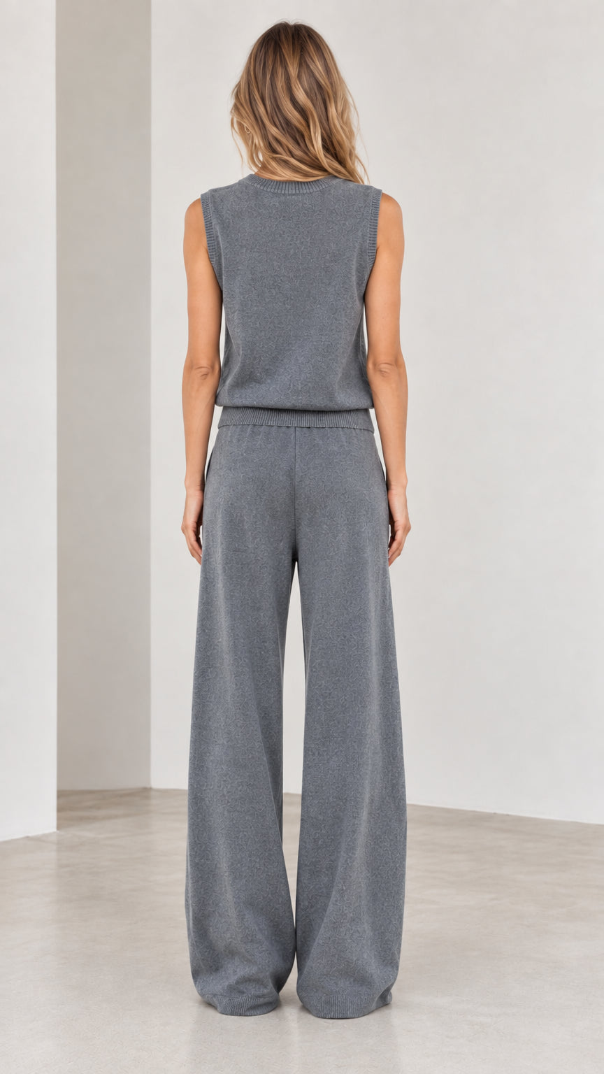 Back view of woman wearing Slate Grey sleeveless knit top and wide-leg knit pants
